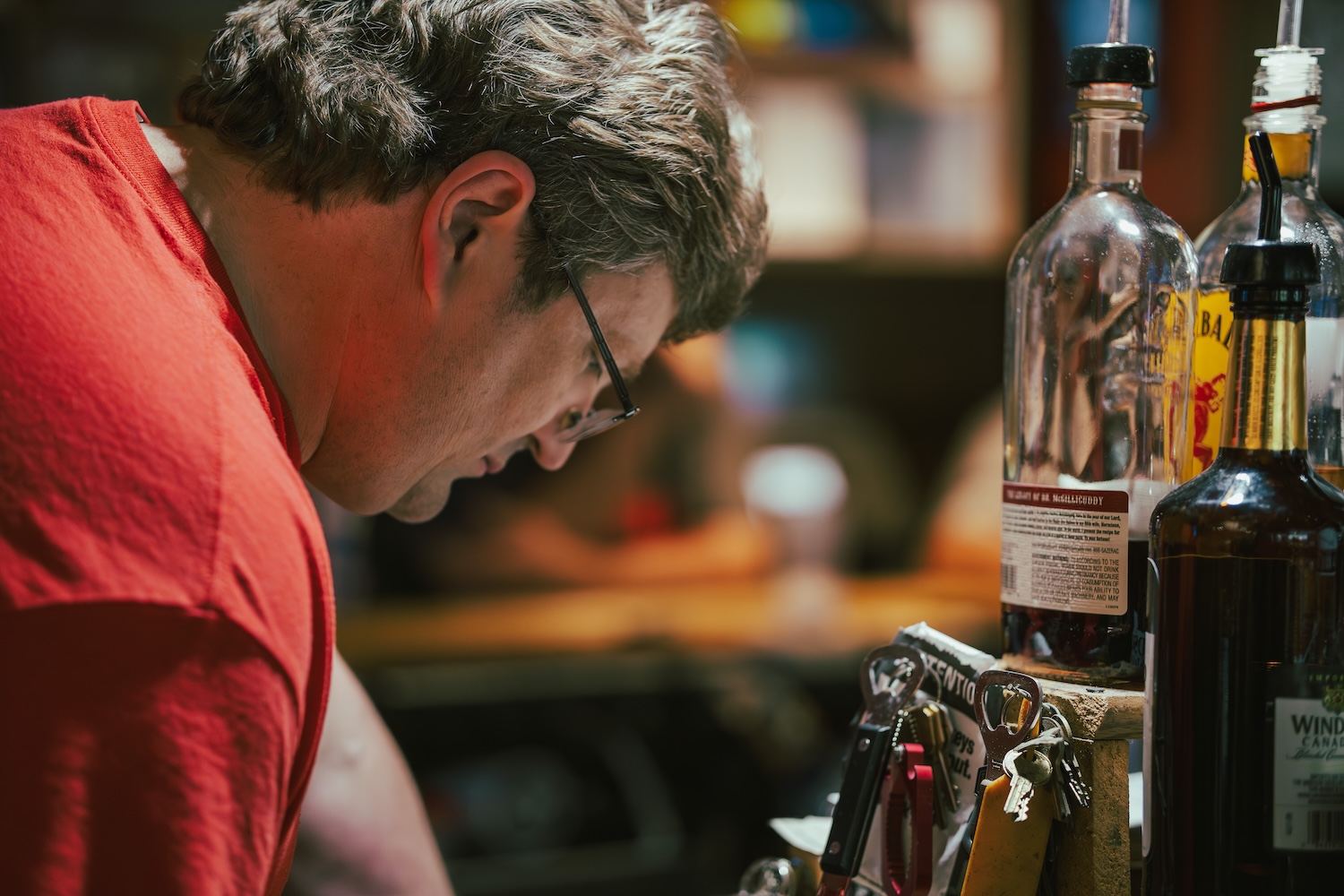Candid photograph of a person working behind a bar