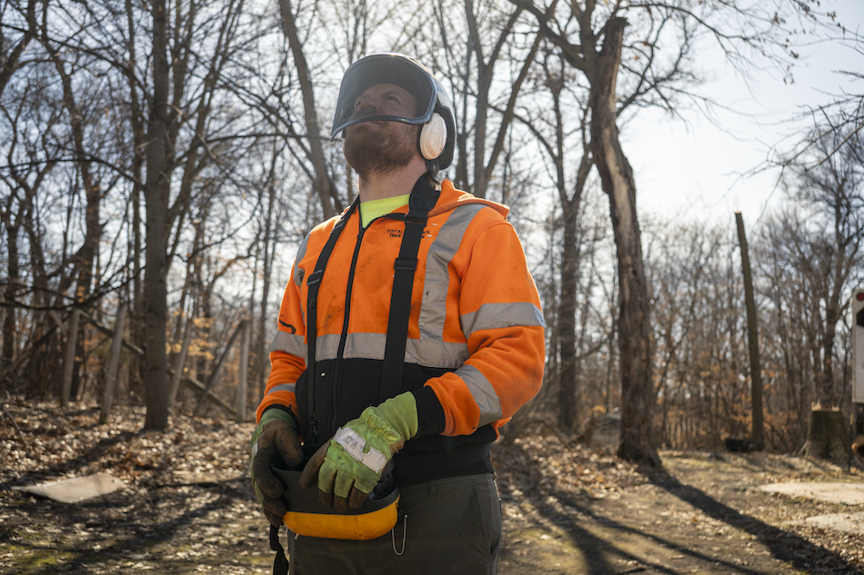 Total Control Tree Service operating a remote-controlled saw and crane